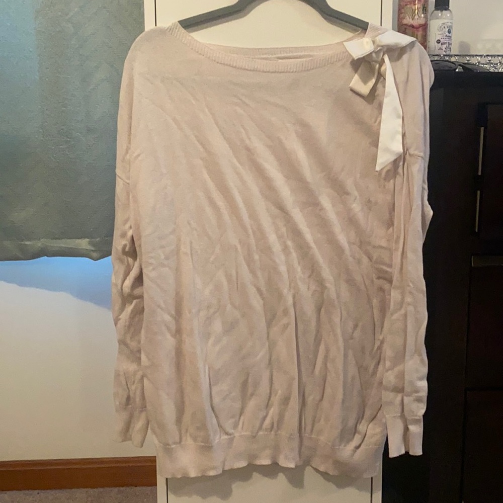 26. Light pink sweater with pink ribbon bow